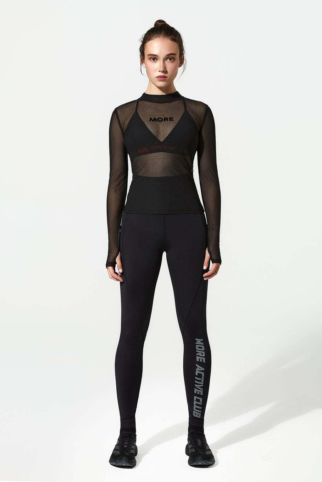 Model wearing a black training top with black running leggings with More Active Logo