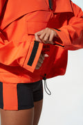 More Active ladies windbreaker jacket​ in orange jacket with a brand logo on a white background