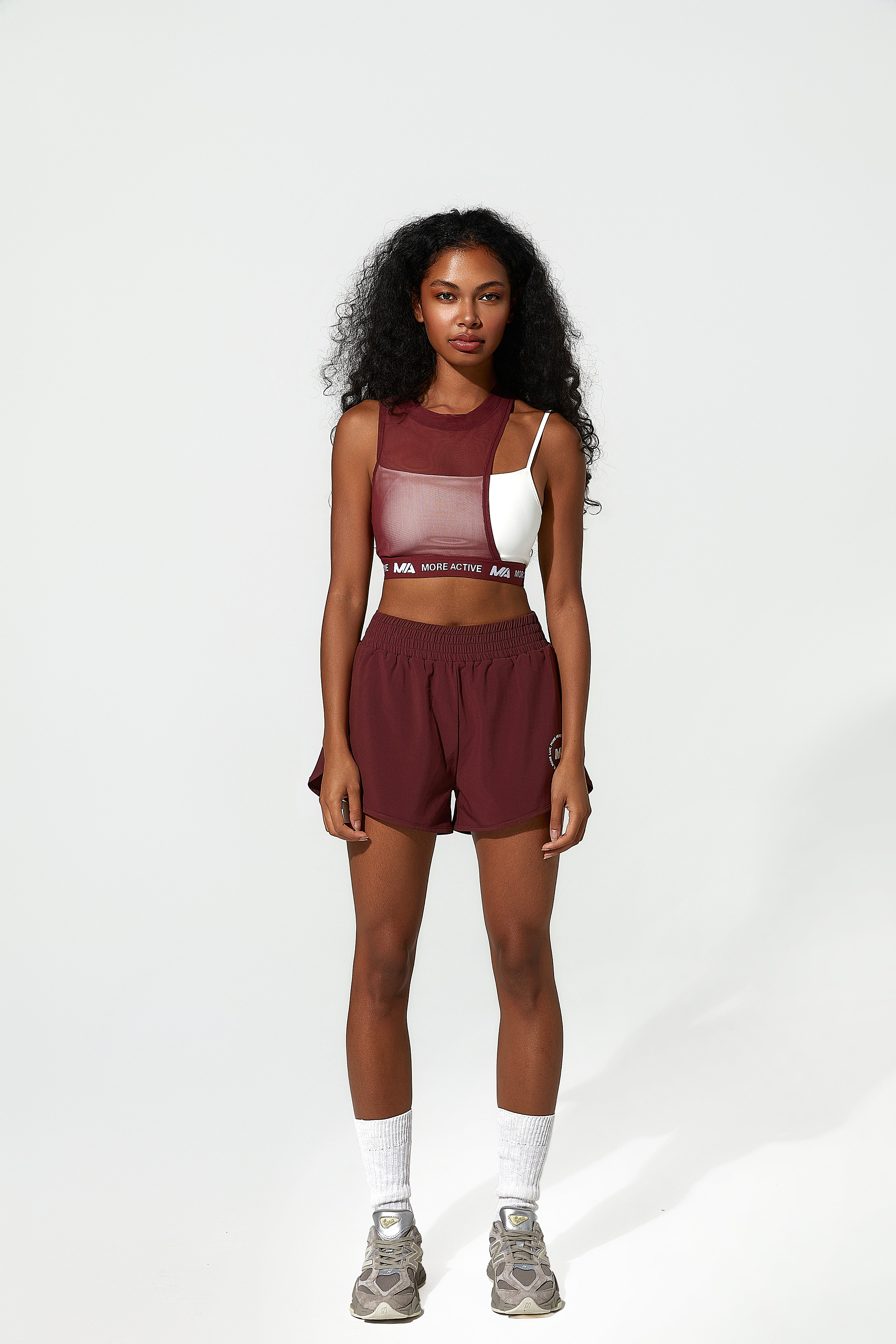 Woman wearing a maroon and white  running sports bra