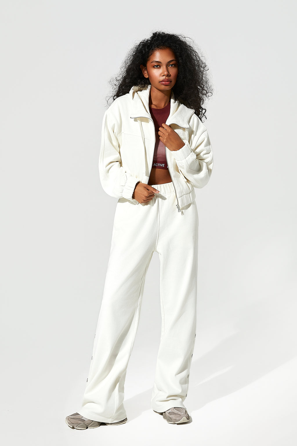 Woman wearing a white zip up hoodie​