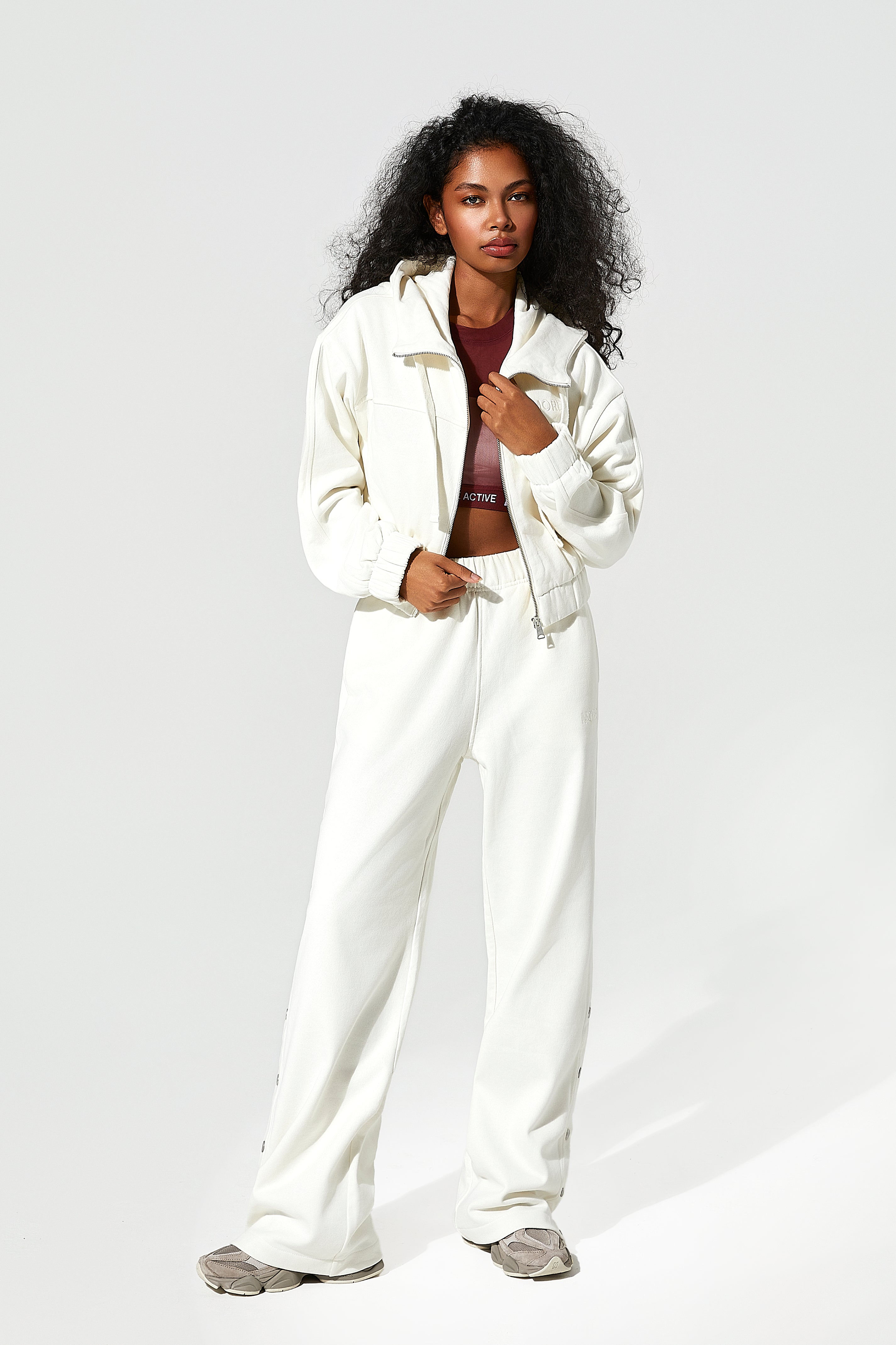 Woman wearing a white zip up hoodie​