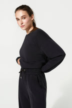 Woman wearing a black outfit on a white background