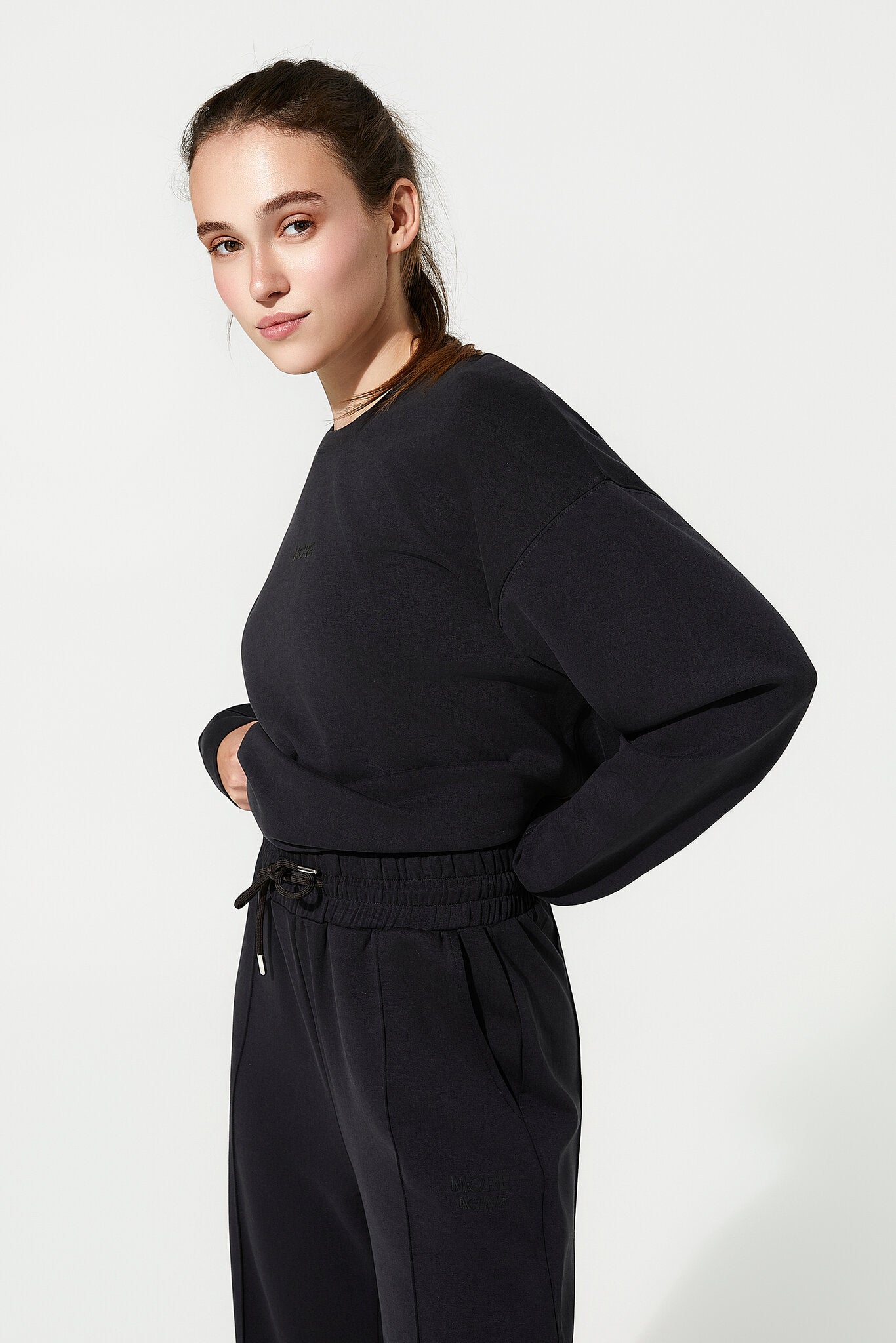 Woman wearing a black outfit on a white background