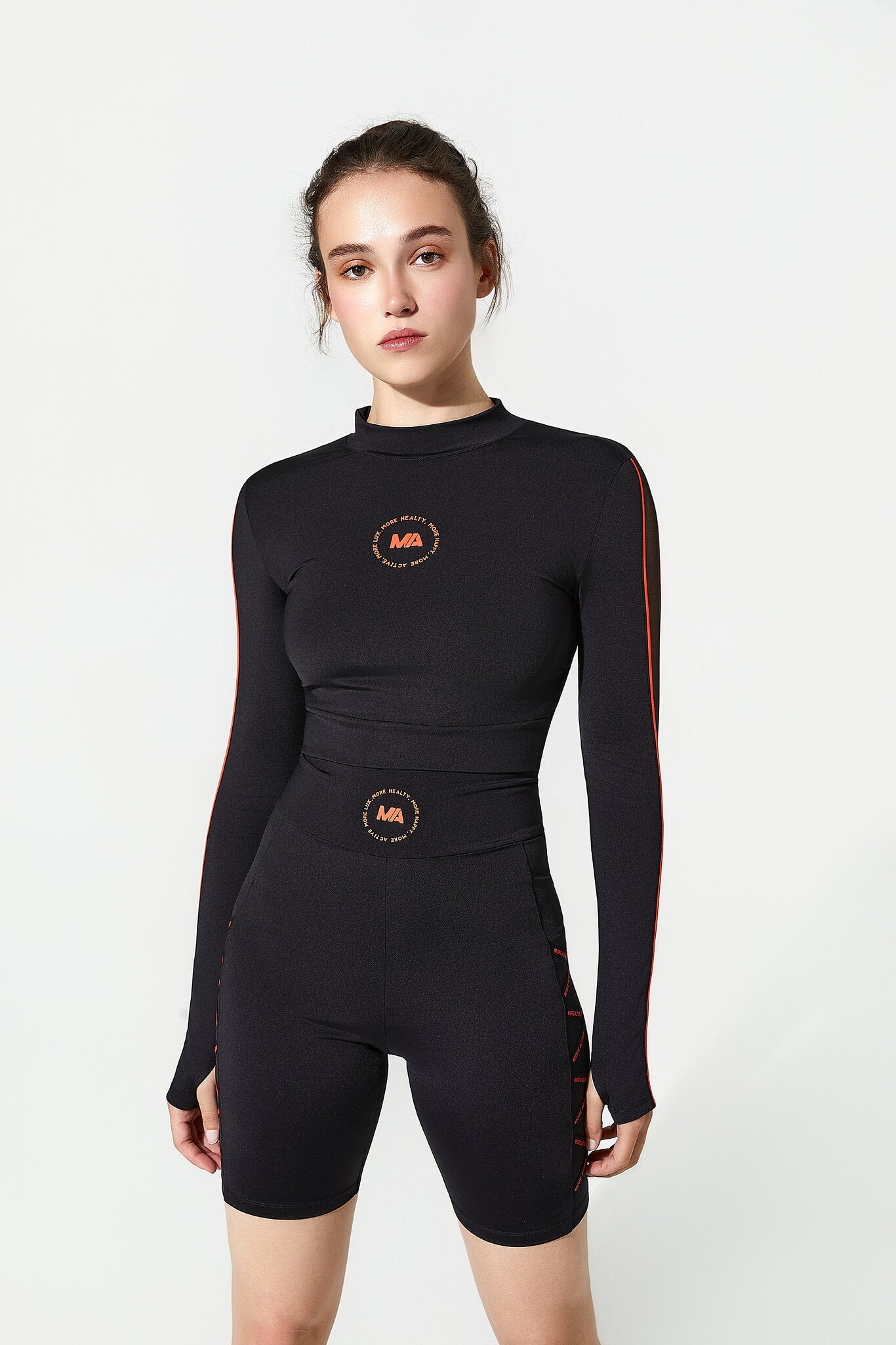 Person wearing a black Gym Top with logos on a white background