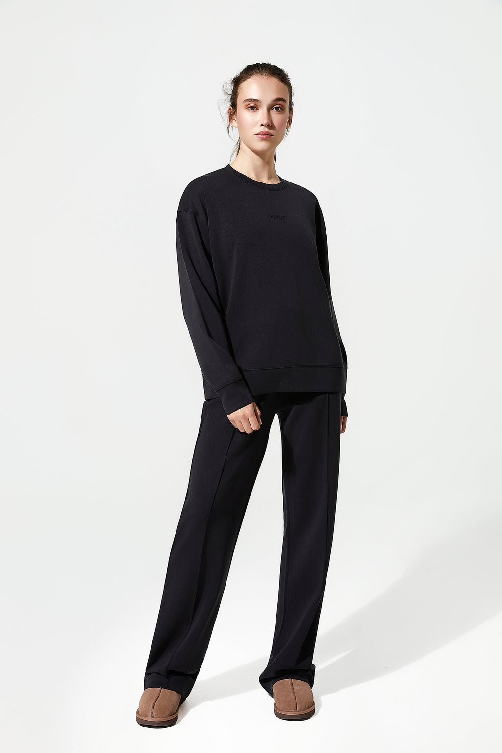 Person wearing a black outfit on a white background