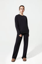 Person wearing a black outfit on a white background