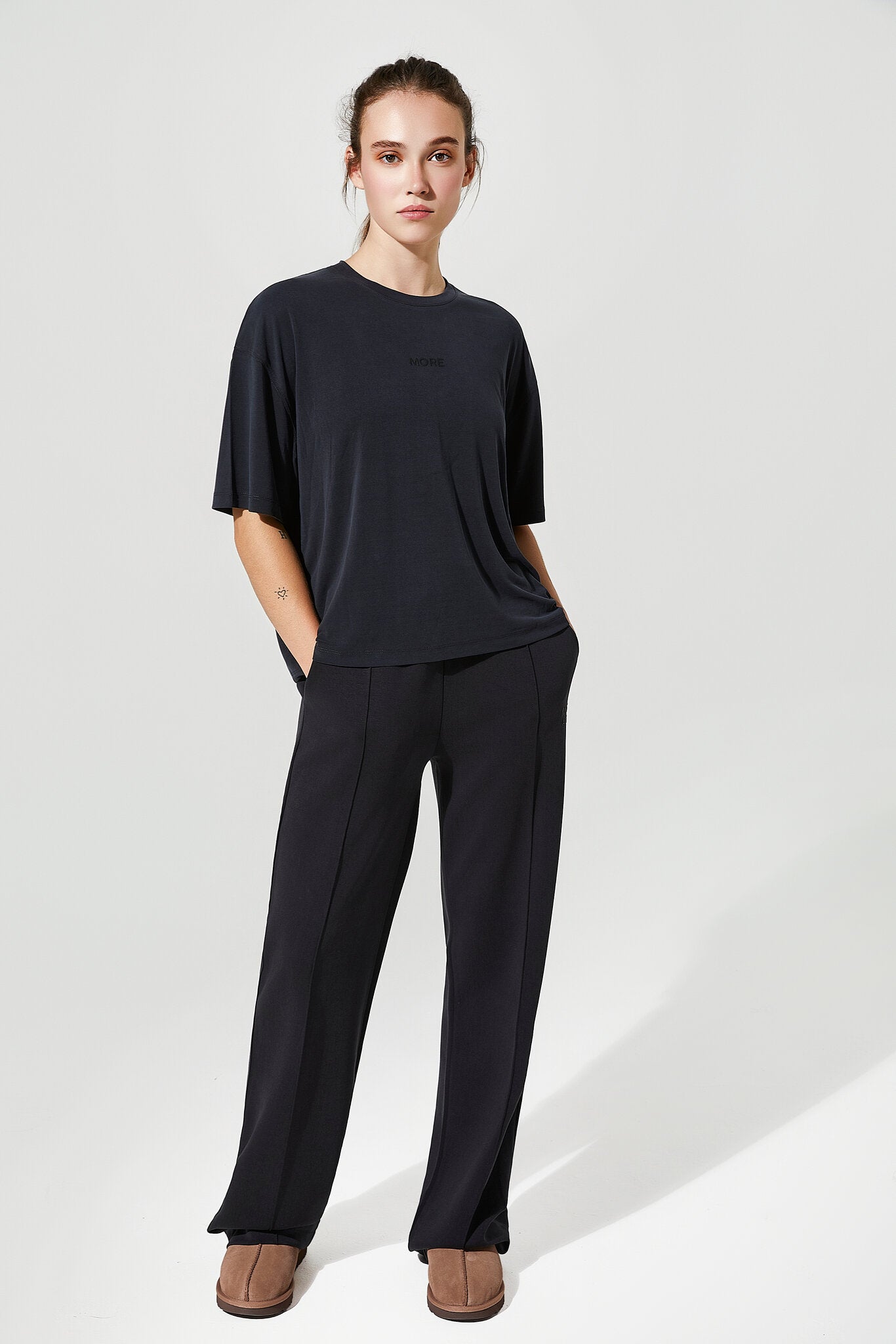 Person wearing a black outfit on a white background