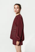 Person wearing a maroon athletic outfit on a white background