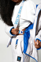 Person wearing a white tracksuit with blue accents and 'More Active' branding.
