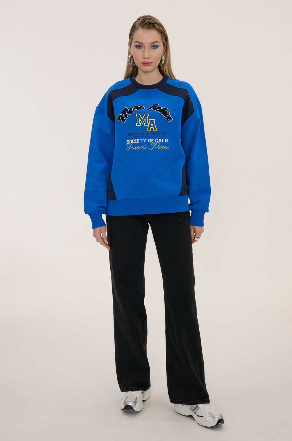 Person wearing a blue and black tracksuit with visible branding on a white background