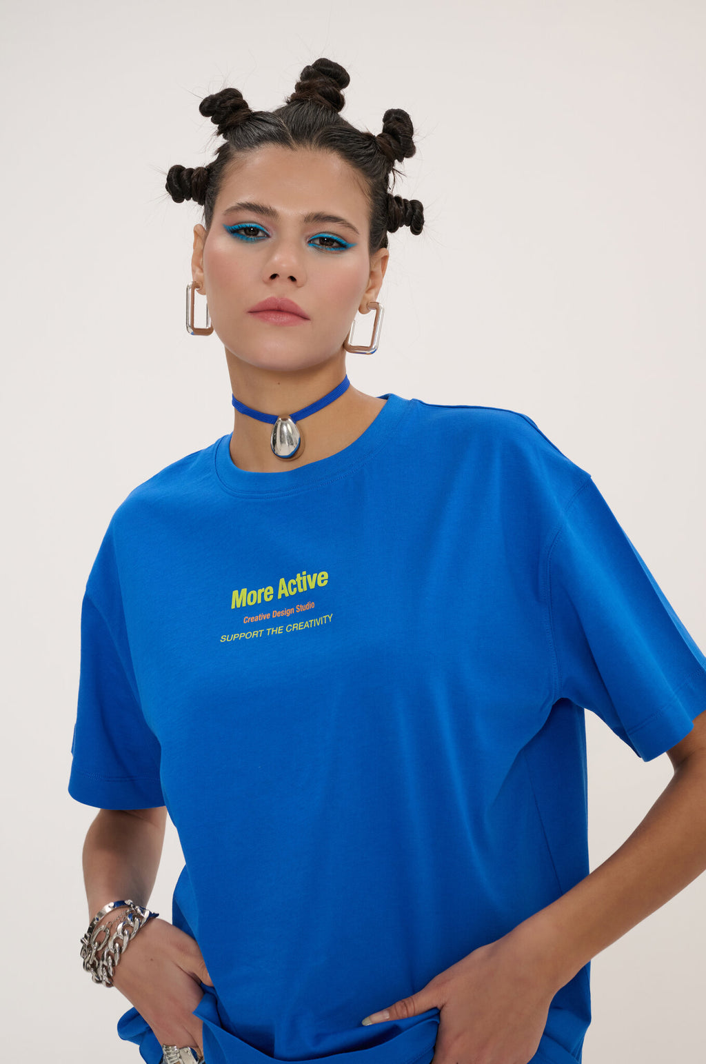 Person wearing a blue t-shirt with text on a plain background