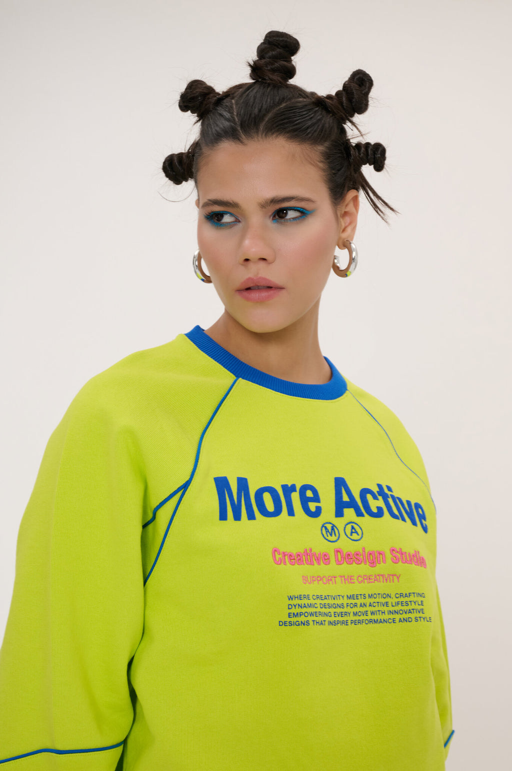 Person wearing a bright green sweatshirt with text on a plain background