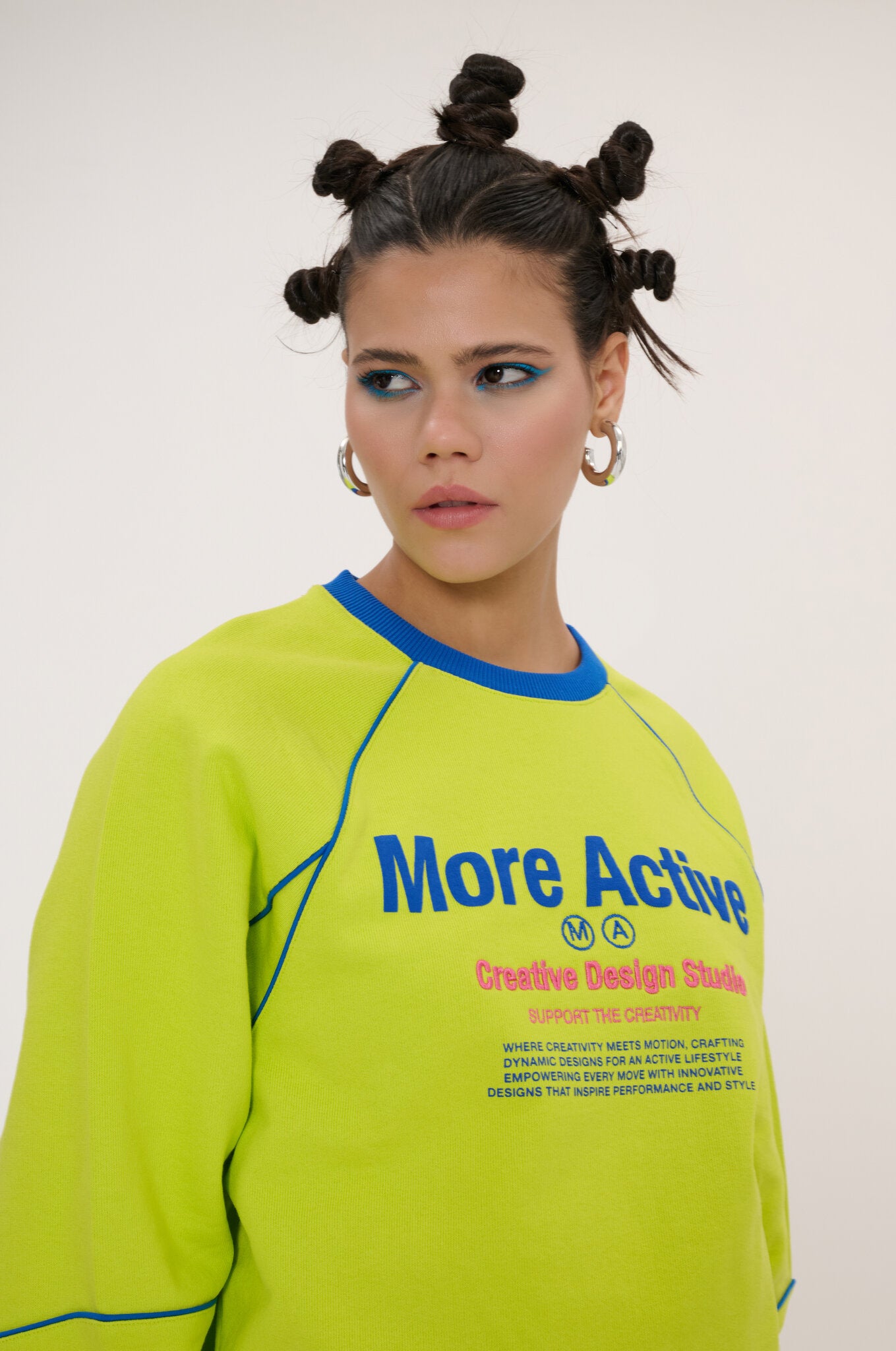 Person wearing a bright green sweatshirt with text on a plain background
