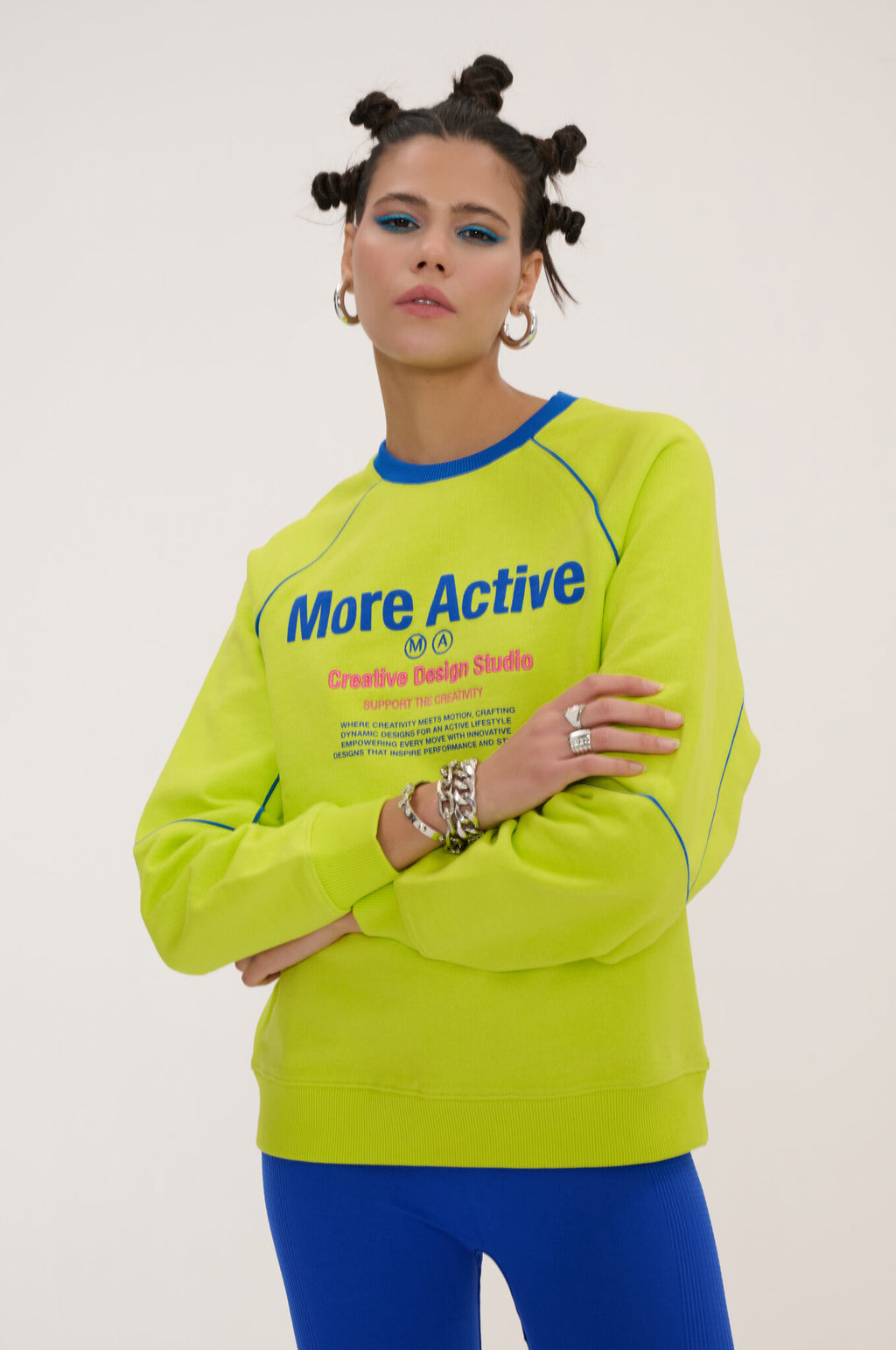 Person wearing a bright yellow sweatshirt with text on a plain background