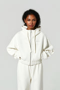 Model wearing a white cropped hoodie and white joggers 