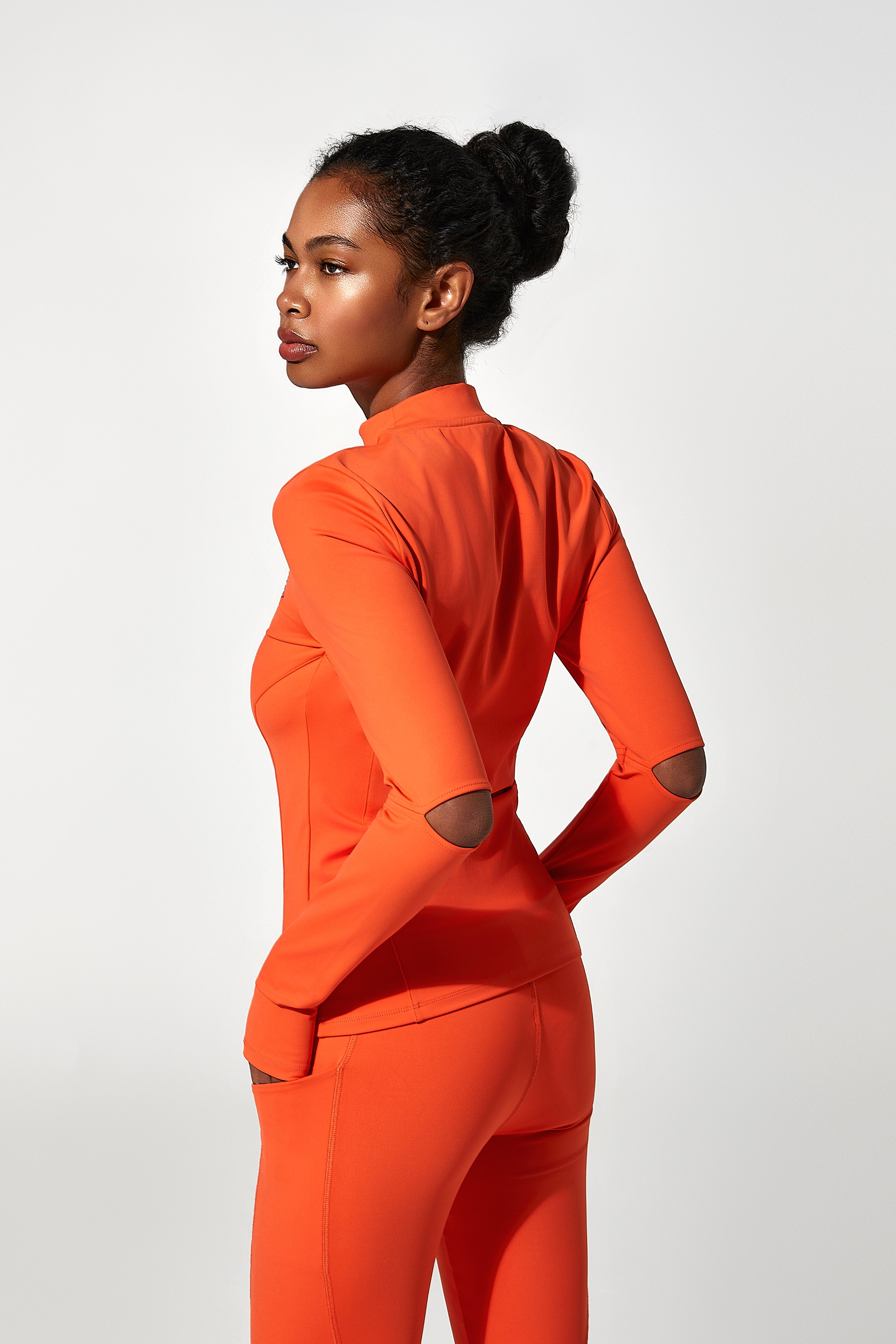 orange Iconic ladies running leggings and gym leggings double as practical leggings with phone pocket, sporting a gymnasium t shirt look for womens gym gear.