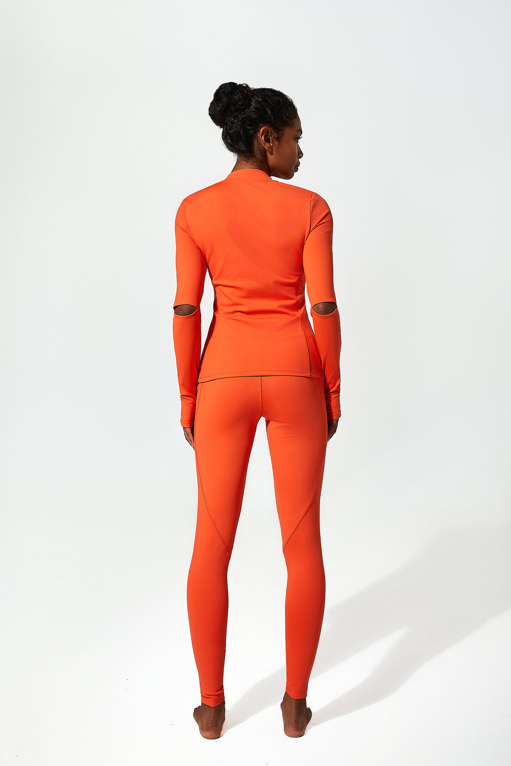 Person wearing an orange outfit on a white background