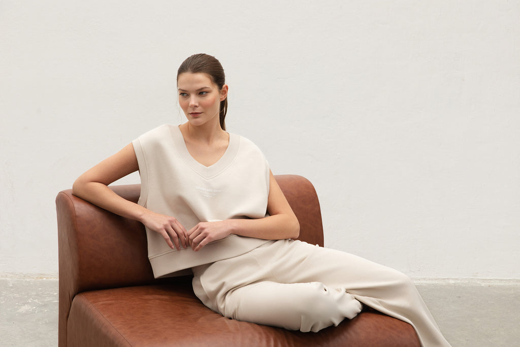 sleeveless_jumper_model_sitting_on_couch_V_Neck